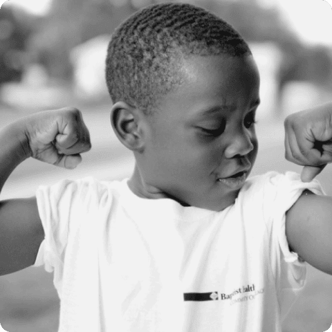 A child flexing both arms